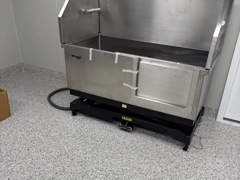 Stainless steel tub installed on a stand in a new commercial space