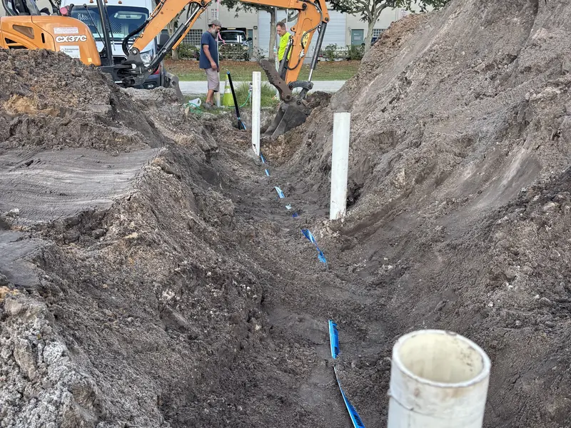 Open trench with new underground water and sewer lines on a construction site
