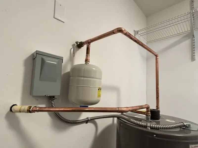 Water heater with new copper piping and expansion tank on the wall